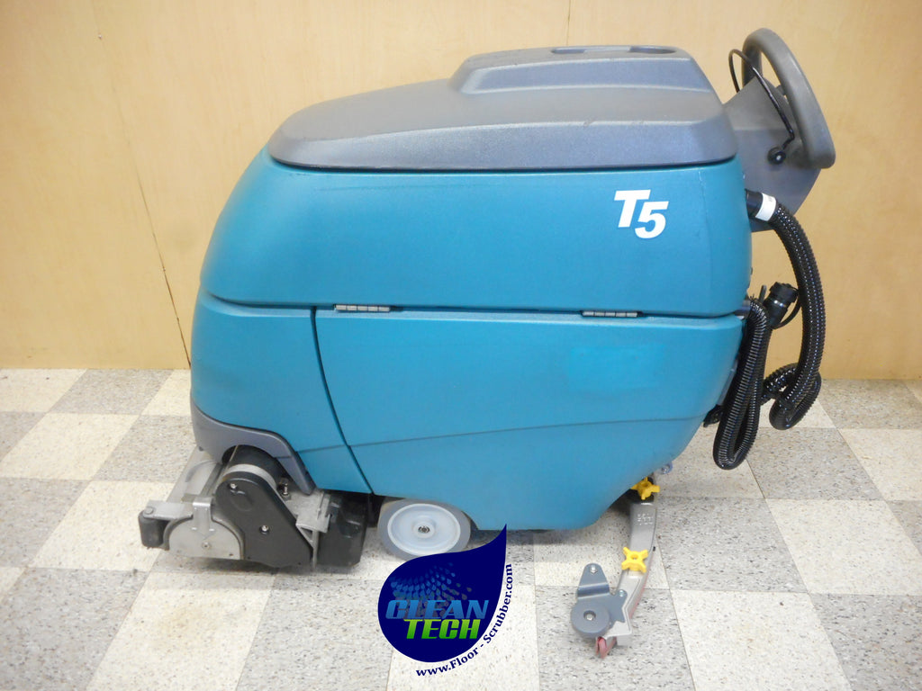 Tennant T5 cylindrical walk-behind floor scrubber front view on warehouse floor