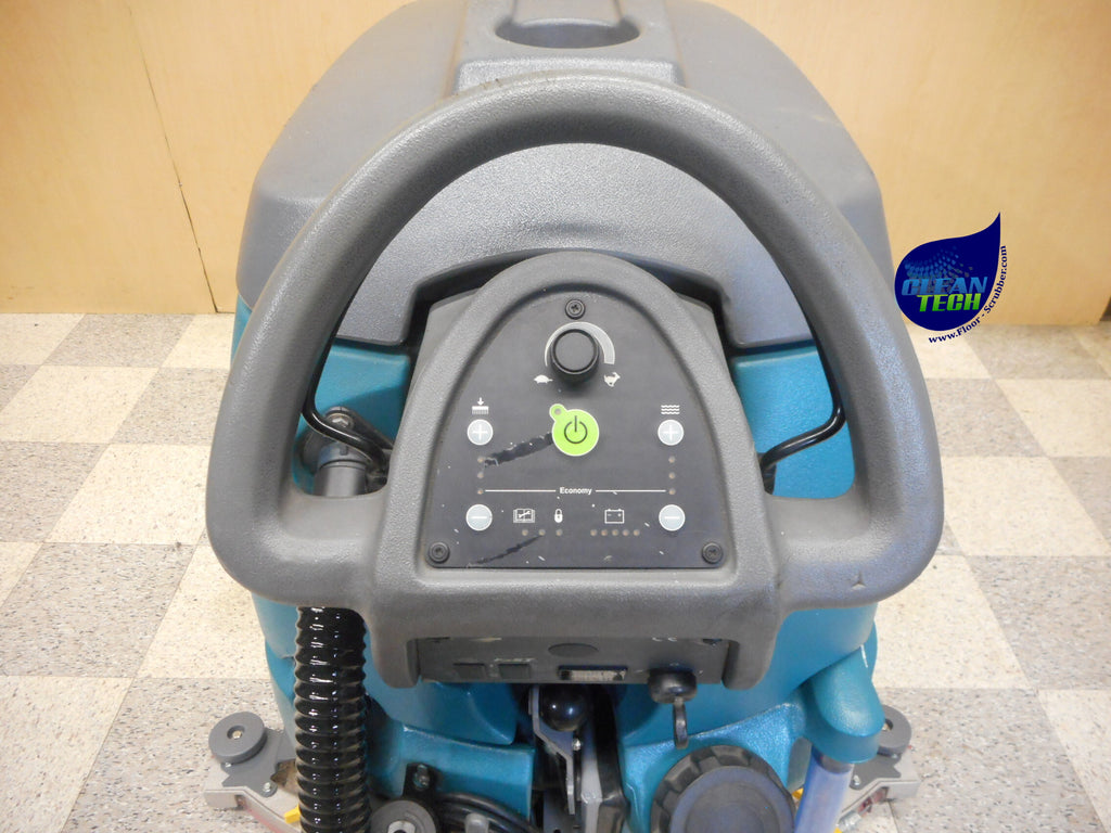 Tennant T5 industrial floor scrubber operating in a warehouse environment